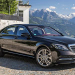 Image of the Mercedes S class with a mountain in the background and this is one of the cars we use for our services