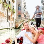 A couple in love on a boat on the river in Venice and they got there thanks to our Chauffeur Service Venice